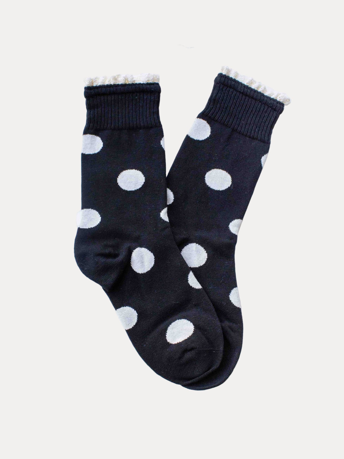 Black socks with white polka dots on a white background